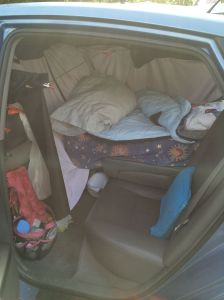 sitting area and bed as viewed from the drivers side back seat door