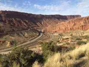 In this picture the red wall I'm talking about is to the left of the road.  This is taken from Arches National Park, but this wall continues into and on through Moab, along 191.